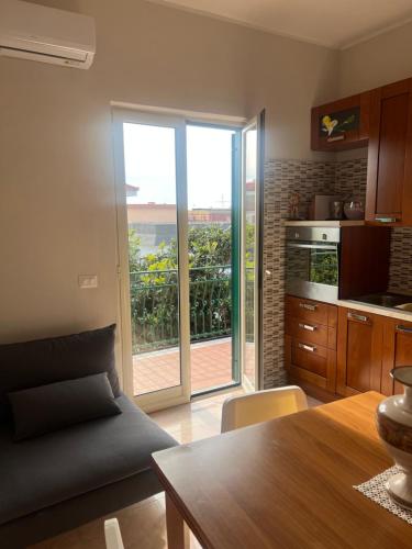 a kitchen with a table and a view of the ocean at Esther Guest House in Castel Volturno