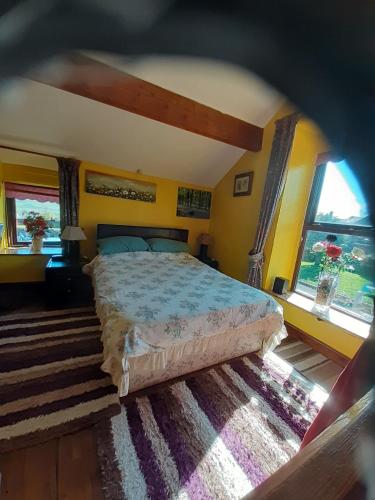 a bedroom with a bed and two windows at Old Coach House in Matlock