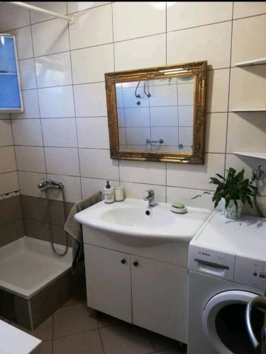 a bathroom with a sink and a washing machine at Smještaj Latica in Vela Luka