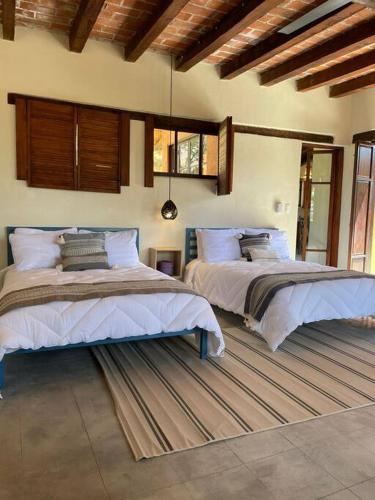 1 dormitorio con 2 camas en una habitación en Casa del Campo en Oaxaca de Juárez