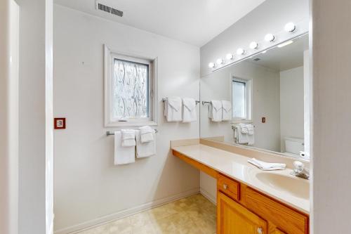 a white bathroom with a sink and a mirror at Trinity Place Treasure in Ocean Pines