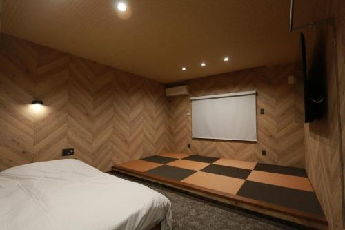 a bedroom with a bed and a projection screen at Beppu City - House - Vacation STAY 16265v in Beppu