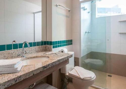 a bathroom with a sink and a toilet and a shower at Enjoy Solar das Águas Park Resort in Olímpia