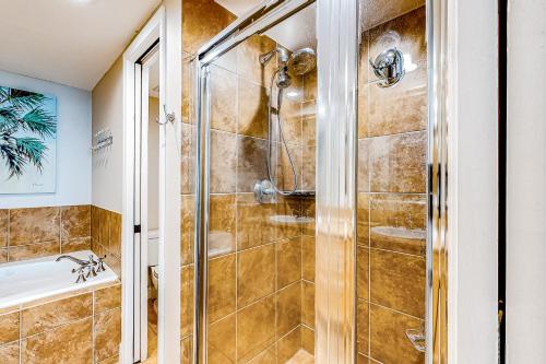 a bathroom with a shower and a tub at Portofino #2009 in Pensacola Beach