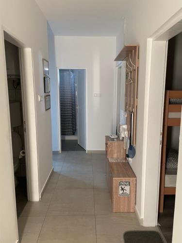 a hallway with a room with white walls at Katarina Rooms in Novi Kneževac