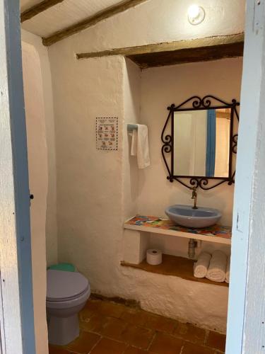a bathroom with a sink and a toilet at Casa de la Piedra in Barichara