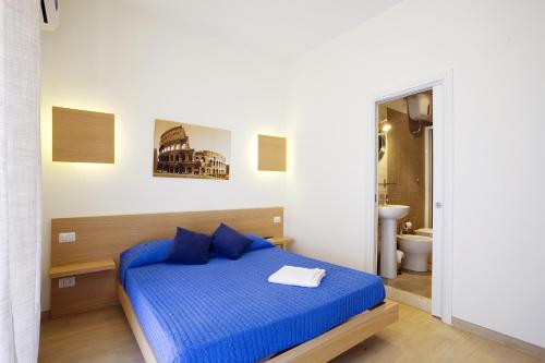 - une chambre avec un lit bleu et une salle de bains dans l'établissement Affittacamere Nansen, à Rome