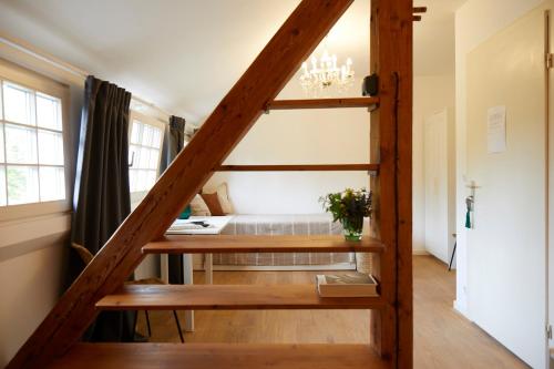 a staircase in a room with a bed and a table at Schloss Mörlbach in Icking