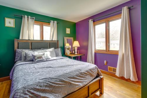 a bedroom with purple and green walls and a bed at Lovely Ocean Gate Home Less Than 1 Mi to Beach! in Ocean Gate