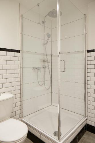 a shower with a glass door in a bathroom at Schloss Mörlbach in Icking