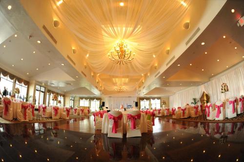 a banquet hall with red chairs and a chandelier at Resort at Longboat Key Club in Sarasota