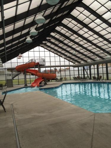 a swimming pool with a slide in a building at Grand Smokies Resort Lodge Pigeon Forge in Pigeon Forge