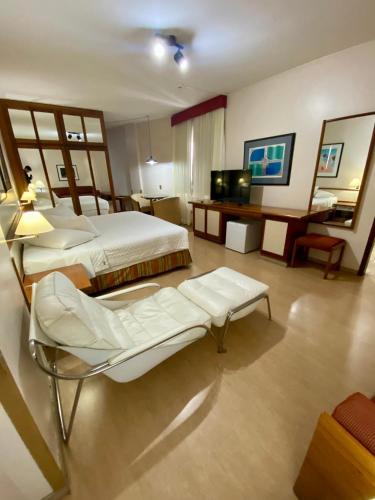 a hotel room with two beds and a television at César Park Hotel in Juiz de Fora