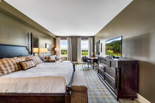 a bedroom with a large bed and a flat screen tv at Pursell Farms in Fayetteville