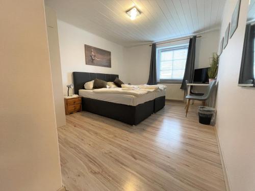 a bedroom with a bed and a desk in it at Ellada Restaurant & Hotel in Tarp