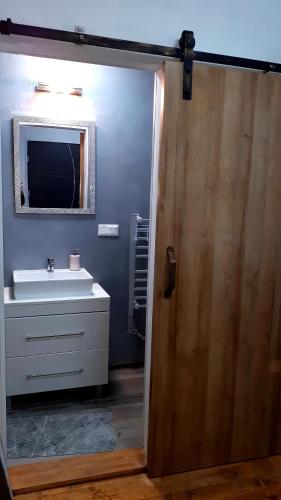 a bathroom with a sink and a mirror at Penzión Florens, Nesvady in Nesvady