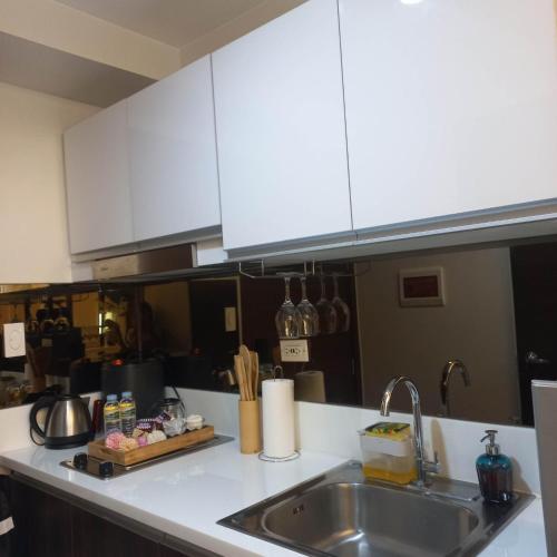a kitchen with a sink and a counter top at Luxurious Condotel at the heart of Makati in Manila