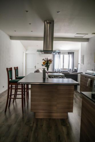 a kitchen with a kitchen island with a counter top at Auberge Sainte Marguerite in La Garde