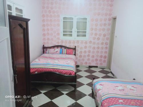 En eller flere senge i et værelse på الوحيد للإستثمار العقارى برأس البر