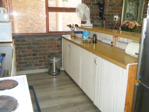 a kitchen with a sink and a counter top at SEA WAY SELFCATERING ACCOMMODATION BETTYS BAY in Bettyʼs Bay