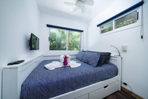 a bedroom with a bed with a stuffed animal on it at Playa Potrero - Cute, modern Containerhome with pool for 2 people in Potrero