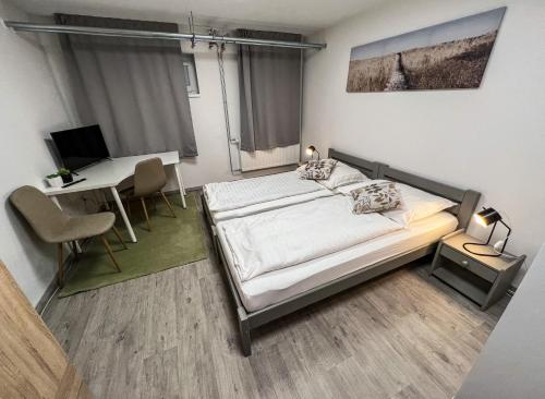 una camera con letto e scrivania con computer di Hostel H18 a Bardejov