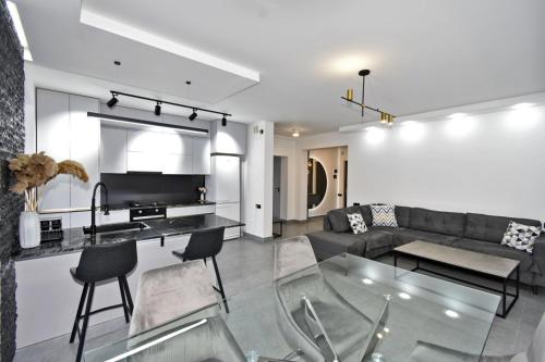 a living room with a couch and a glass table at Luxury Apartment, 2 bedrooms and 1 living room in Avan in Yerevan