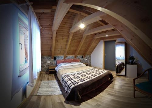 a bedroom with a large bed in an attic at Apartman Tonka in Otočac