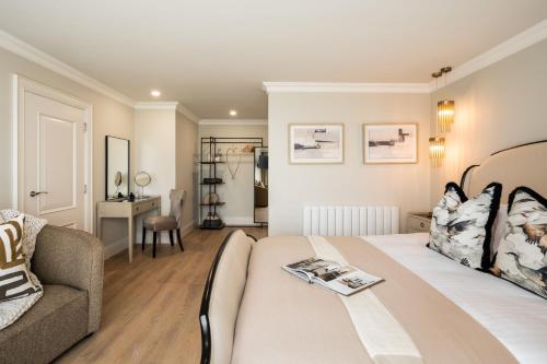 a bedroom with a bed and a couch and a table at Atlantic View in Portstewart