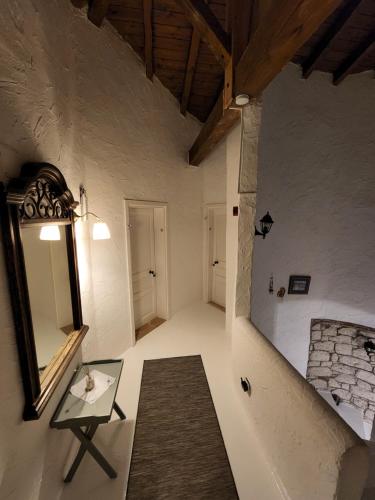 a room with a glass table and a mirror at Jakamar Alacati in Alacati