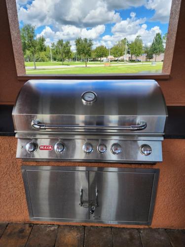 a stainless steel stove with a window behind it at Spacious Apartment Near Disney in Kissimmee