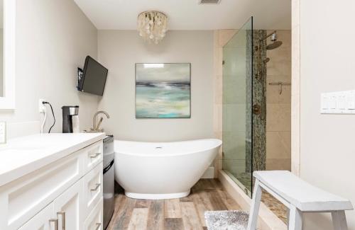 a bathroom with a tub and a glass shower at Spacious, Luxury Ocean Master Suite 2 BD With Kitchenette in San Diego