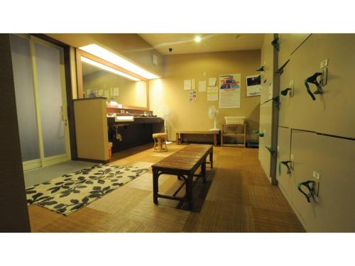 a room with a bench and a table in it at Yoro Onsen Honkan - Vacation STAY 09608v in Onomichi