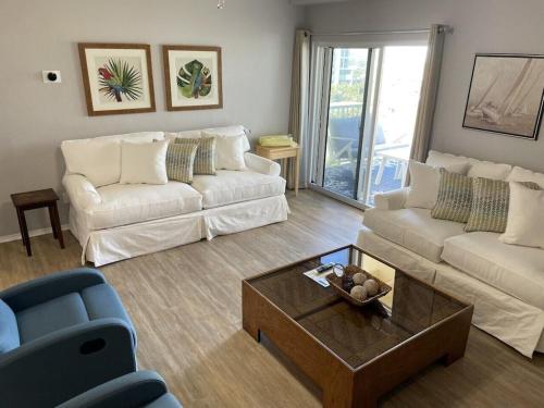 a living room with a couch and a coffee table at A Wave From It All in Pensacola Beach