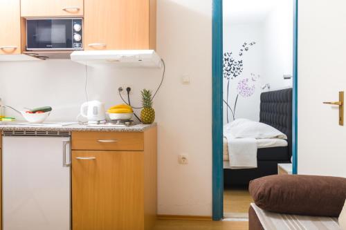 a small kitchen with a sink and a counter at Guest House Marinna in Vrboska