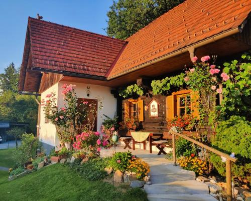 a house with a red roof and a patio at Pension Treissmann in Pichling bei Stainz
