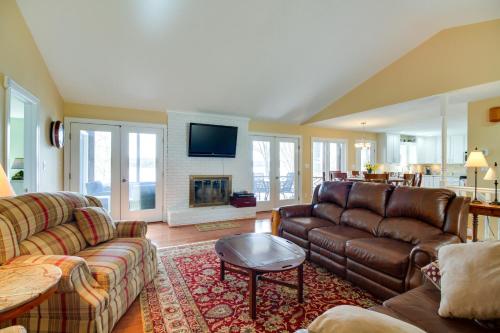 a living room with a couch and a fireplace at Smith Mountain Lake Getaway with Private Dock! in Moneta