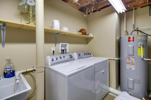 a laundry room with a washing machine and a refrigerator at Smith Mountain Lake Getaway with Private Dock! in Moneta