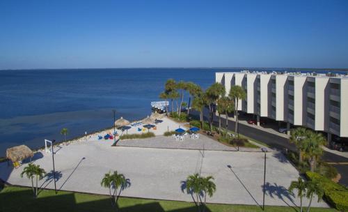 a view of a beach with a building and the ocean at Sailport Waterfront Suites in Tampa