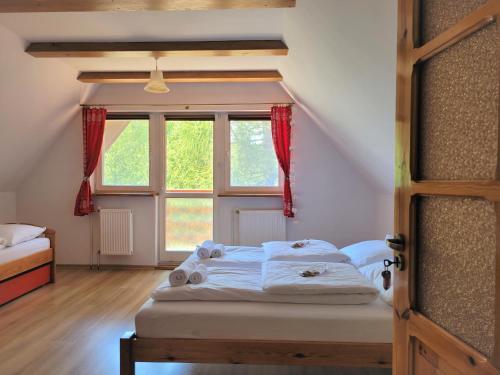 a bedroom with a bed and a window at Maja 37 in Janowice Wielkie