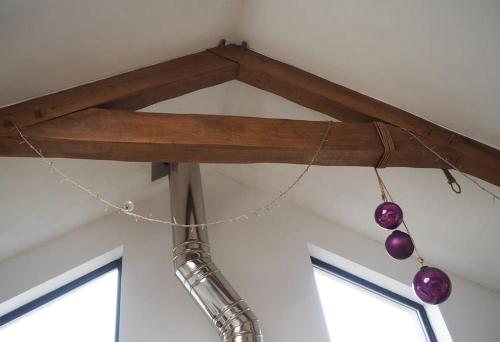 a wooden beam with purple ornaments hanging from it at Fern Lodge Angus, Kirriemuir in Angus