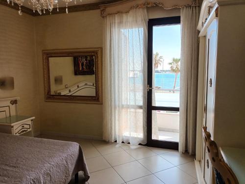 una camera con letto e vista sull'oceano di DIO DEL MARE LUXURY ROOM a Porto Cesareo