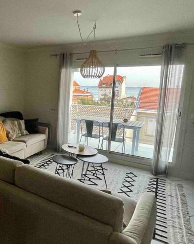 a living room with a couch and a table at Nice Appartment in Arcachon, near the beach in Arcachon