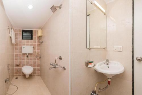a bathroom with a shower and a sink and a toilet at KALPANA RESIDENCY - Near US Embassy in Mumbai