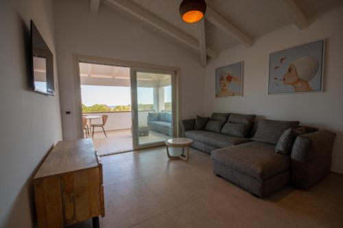 a living room with a couch and a table at ENAJA - Luxury Retreat in Budoni