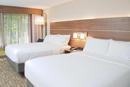 a hotel room with two beds and a window at Holiday Inn Express South Burlington by IHG in Burlington