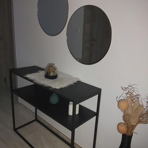 a black table with a mirror on a wall at La belle Éden Gite Bastogne in Bastogne