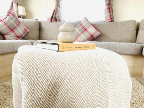 a teddy bear sitting on a book on a table at Sea Breeze in Scarborough