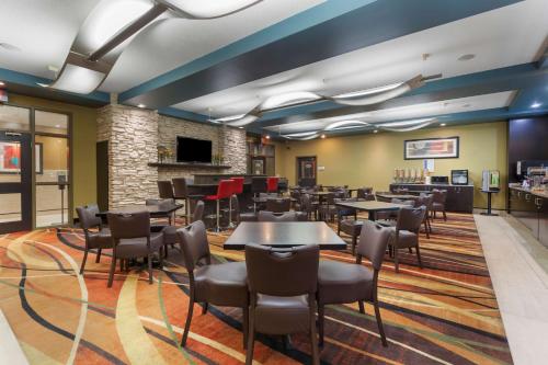 a restaurant with tables and chairs in a room at Best Western Plus Sherwood Park Inn & Suites in Sherwood Park