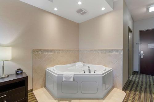 a bathroom with a white tub and a sink at Best Western Plus Sherwood Park Inn & Suites in Sherwood Park